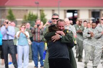 Col. Gentry W. Boswell, former 28th Bomb Wing commander, hugs his wife, Cindy Boswell, after his final flight at Ellsworth Air Force Base, S.D., Aug. 7, 2017. Boswell now has his sights set on Barksdale AFB, La., where he will serve as the assistant director of operations at the Air Force Global Strike Command headquarters. (U.S. Air Force photo by Senior Airman James L. Miller)