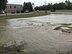 The intersection of Eielson Street and Tuskegee Airman Boulevard flooded after a water main broke on Grand Forks Air Force Base, N.D., Aug. 5, 2017. Airmen from the 319th Civil Engineer Squadron responded, isolated the line and repaired the 8-inch water main, saving $64,000 in contract repair cost. (U.S. Air Force courtesy photo)