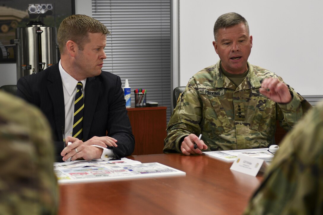 U.S. Army Gen. David G. Perkins, commander of Training and Doctrine Command, right, briefs Acting Secretary of the Army Ryan McCarthy, left,
