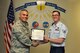 U.S. Air Force Col. Alex Ganster, 17th Training Group Commander, presents the 312th Training Squadron Student of the Month award for July 2017 to Staff Sgt. Justin Vining in Brandenburg Hall on Goodfellow Air Force Base, Texas, August 4, 2017. The 17th Training Wing's mission is to develop and inspire exceptional intelligence, surveillance and reconnaissance, and fire protection professionals for America and her allies. (U.S. Air Force photo by Russell Stewart/Released)