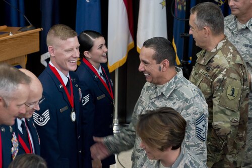 Airmen congratulate The Air National Guard's 2016 Outstanding Airmen of the Year following a recognition ceremony held at the ANG Readiness Center on Joint Base Andrews, Md., August 10, 2017. The honorees, selected from the 90 wings across the ANG are: Staff Sgt. Lacey K. Millier, Florida ANG, Airman of the Year; Tech. Sgt. Jason D. Selberg, Arizona ANG, NCO of the Year; Senior Master Sgt. Thomas DuMont, Missouri ANG, Senior NCO of the Year; and Senior Master Sgt. Jason L. Handa, Arizona ANG, First Sergeant of the Year. (U.S. Air National Guard photo/Staff Sgt. John E. Hillier)