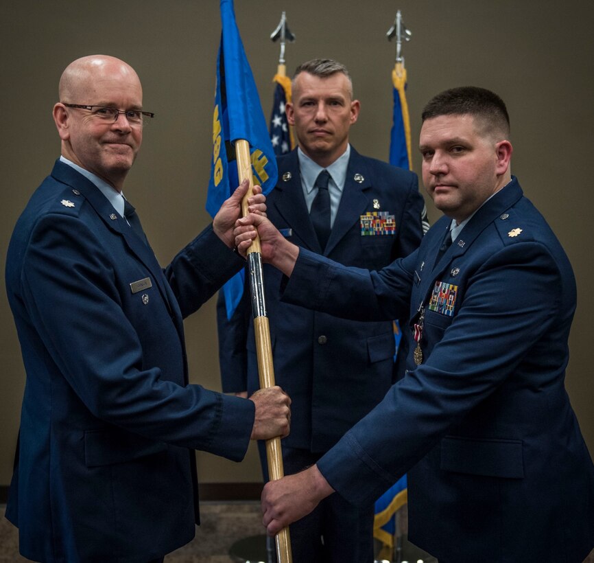 Lt. Col. Wayne Johnson, deputy commander for the 932nd Mission Support Group receives the Logistic Readiness Flight guidon from Maj. Christopher Kaighen Aug. 5, 2017, Scott Air Force Base, Illinois during a change of command ceremony.  Kaighen relinquished command of the 932nd LRF and will take on a new role as 22 AF/A4R Chief, Logistics Readiness Division. (U.S. Air Force photo by Tech. Sgt. Christopher Parr)
