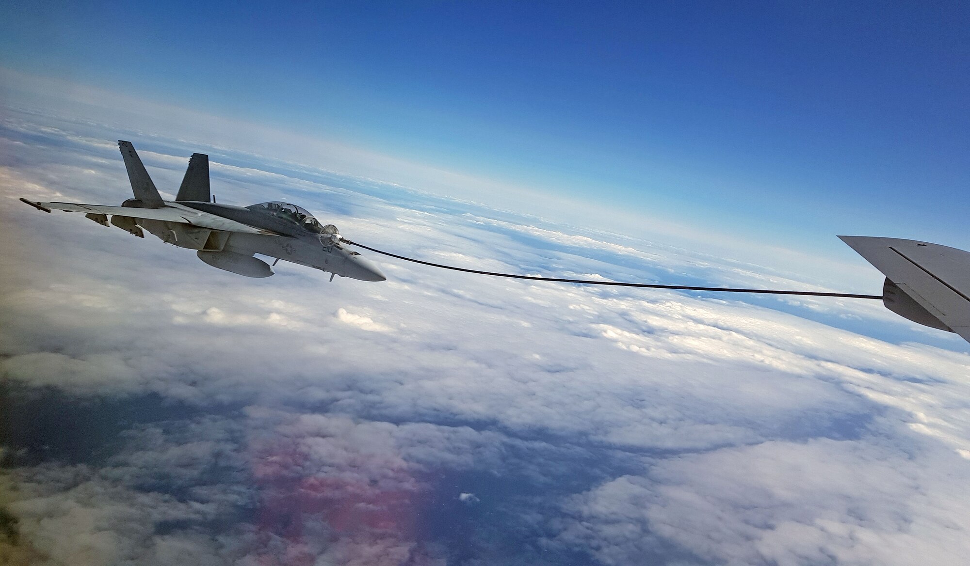 A U.S. Navy F/A 18F Super Hornet, attached to the “Blacklions” of Strike Fighter Squadron (VFA) 213  takes on fuel from a U.S. Air Force KC-135 Stratotanker from Royal Air Force Mildenhall off the coast of Scotland during exercise Saxon Warrior 2017, Aug. 9.