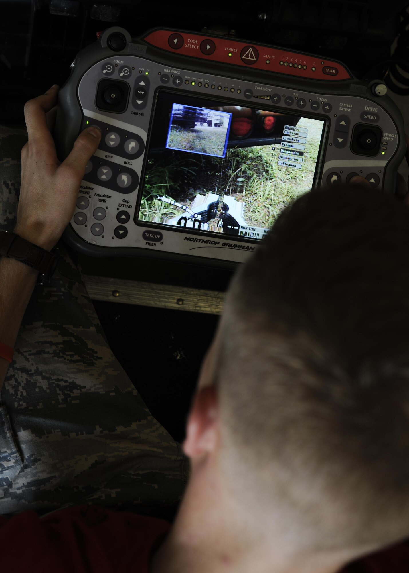 U.S. Air Force Airman 1st Class Aaron Hughes, 8th Civil Engineer Squadron Explosive Ordinance Disposal apprentice, controls an Air Force Medium Sized Robot at Kunsan Air Base, Republic of Korea, Aug. 11, 2017. Airmen from both Osan Air Base and Kunsan Air Base, Republic of Korea had the opportunity to train with an instructor from Remotec, who supply and maintain AFMSRs and other robots for the Air Force, in rebuilding and repairing inoperable robots. (U.S. Air Force photo by Staff Sgt. Victoria H. Taylor)