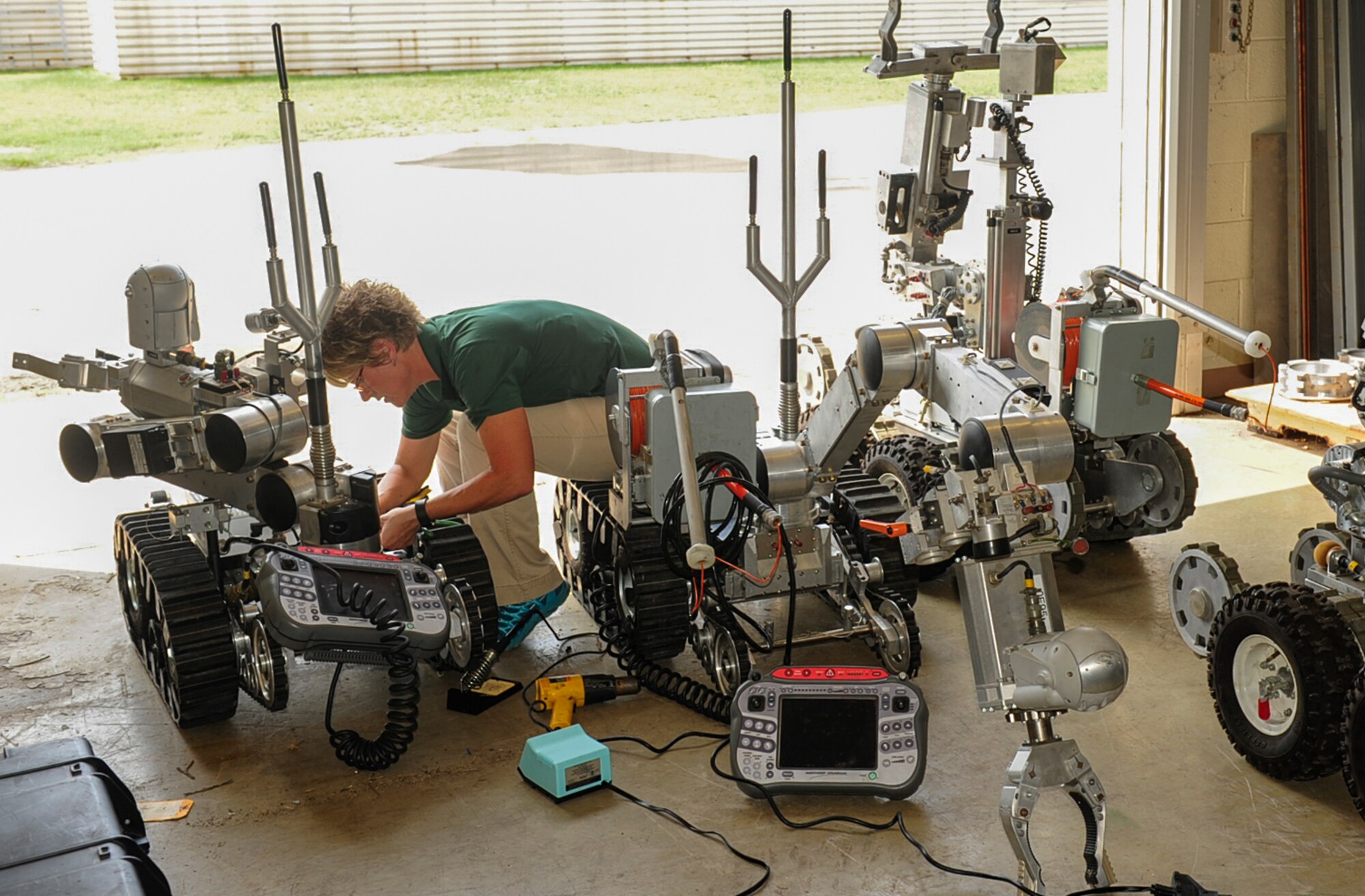 Kimberly Tipton, Remotec instructor, troubleshoots an Air Force Medium Sized Robot at Kunsan Air Base, Republic of Korea, Aug. 10, 2017. Tipton was sent here to teach a week-long class training Explosive Ordinance Disposal Airmen how to perform general repairs on the robots that they use for missions. (U.S. Air Force photo by Senior Airman Colby L. Hardin)