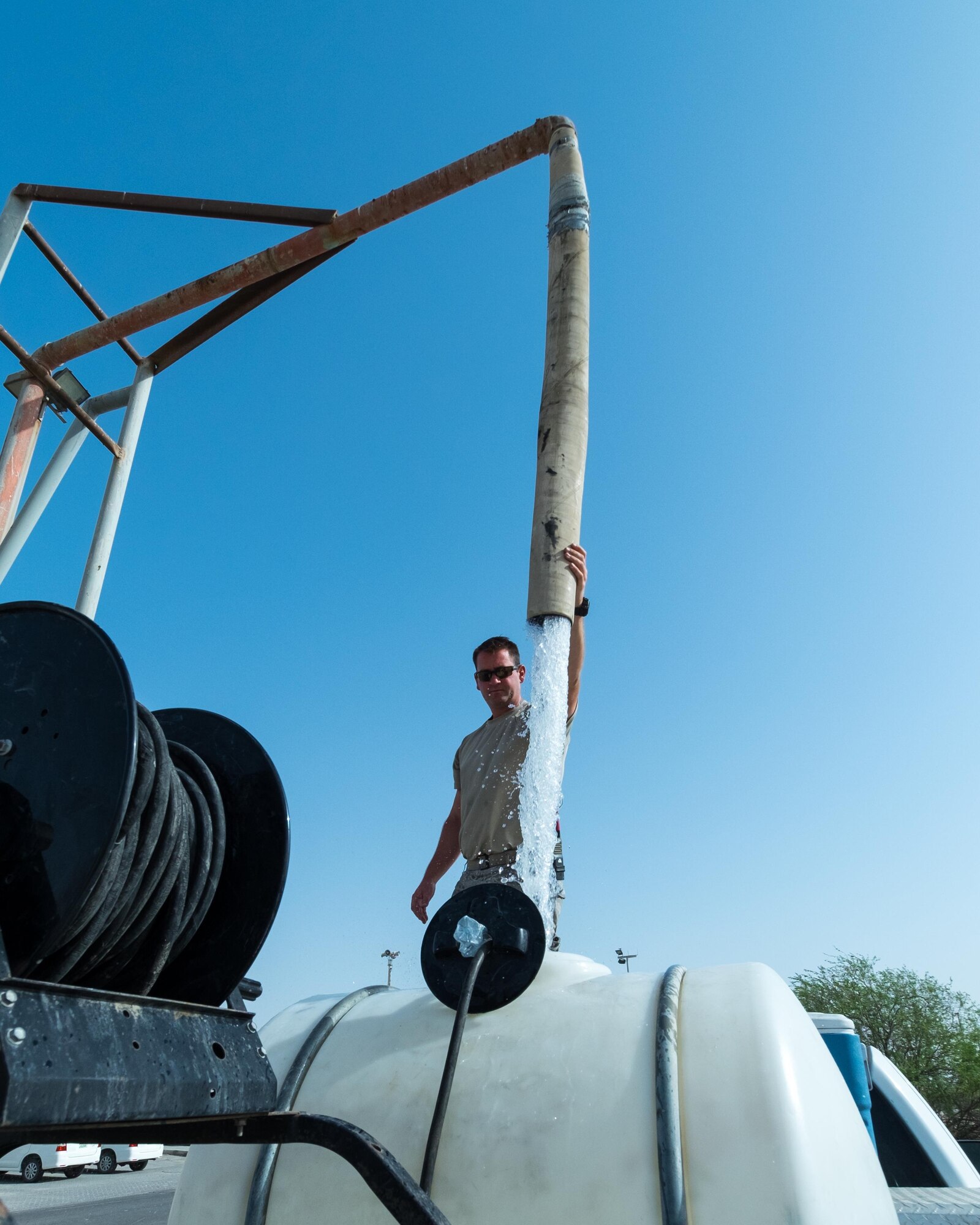 Tech. Sgt. James, 380th Expeditionary Civil Engineer Squadron heating, ventilation, and air conditioning technician, fills a tank with water August 8, 2017, at Al Dhafra Air Base, United Arab Emirates.