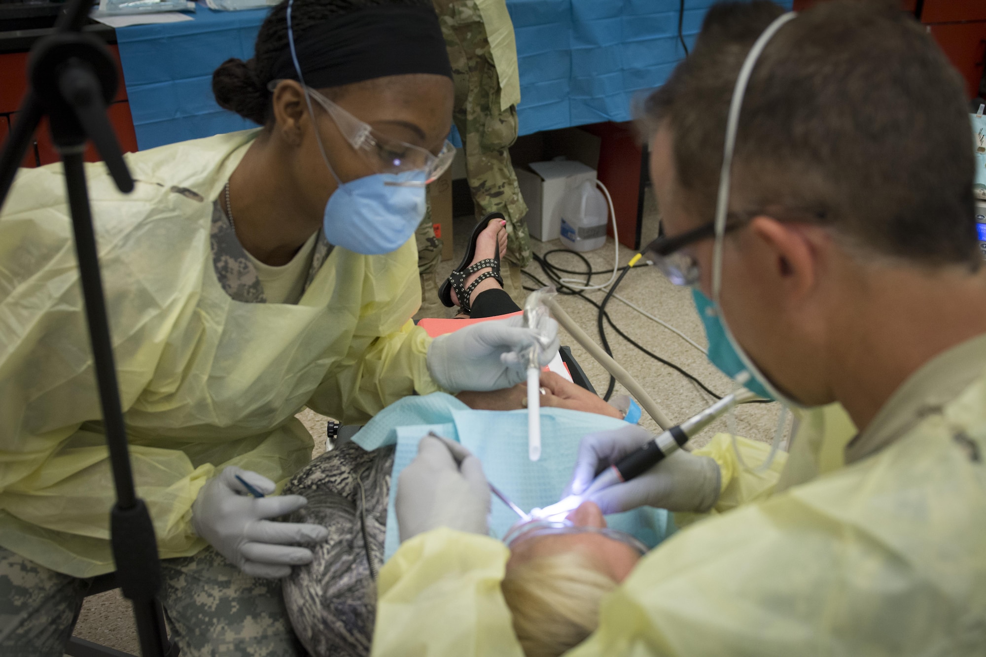 Air Force Lt. Col. Michael Strohecker (right), a dentist assigned to 145th Medical Group, North Carolina Air National Guard, provides a filing at Swain County High School during Smoky Mountain Medical Innovative Readiness Training in Bryson City, N.C., on Aug. 3, 2017.