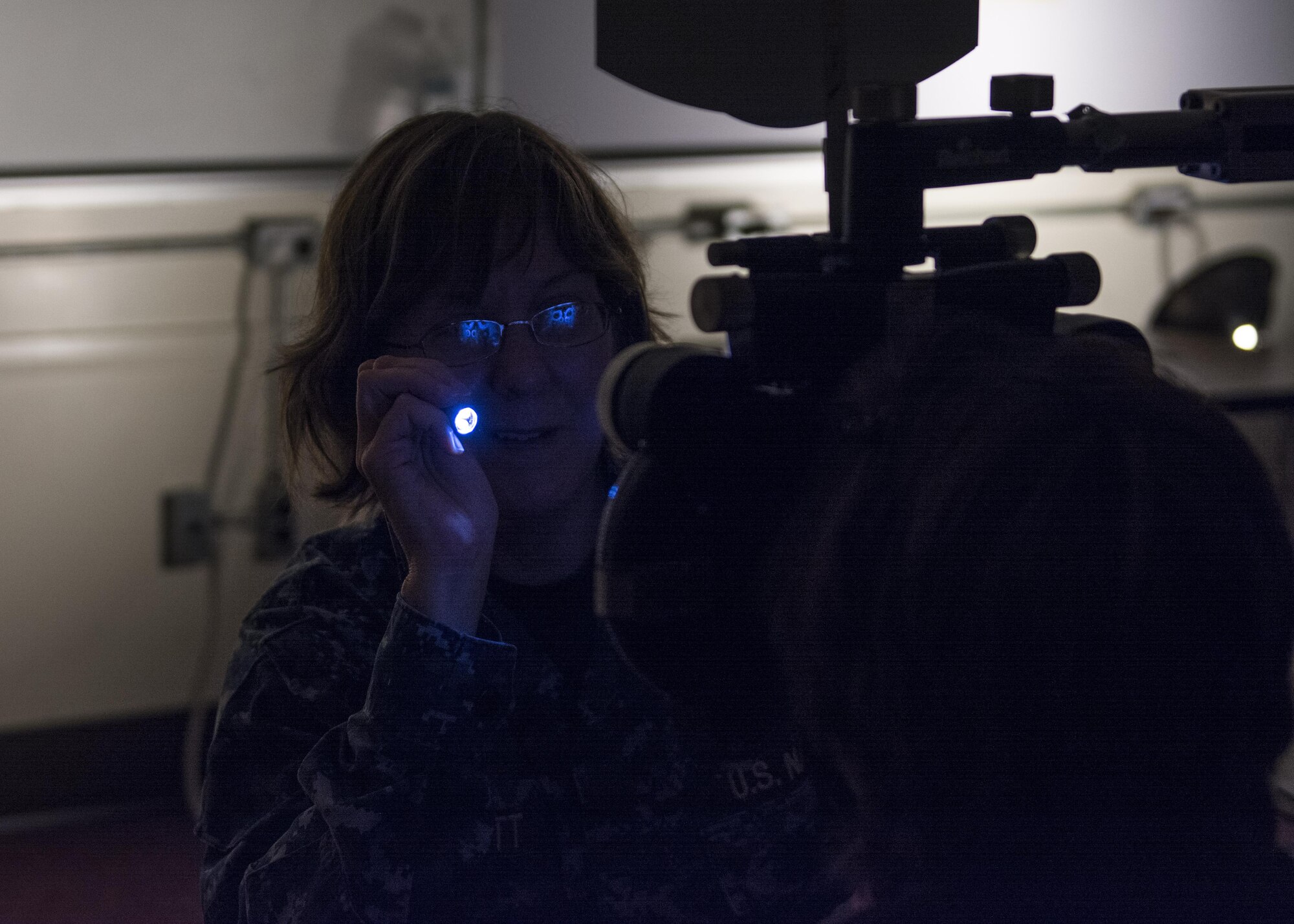 Navy Cmdr. Bonnie Garbutt, an optometrist assigned to Naval Hospital Camp Pendleton, Camp Pendleton, Calif., calibrates a phoropter which will be used to give eye exams at Swain County High School during Smoky Mountain Medical Innovative Readiness Training in Bryson City, N.C., on Aug. 3, 2017.