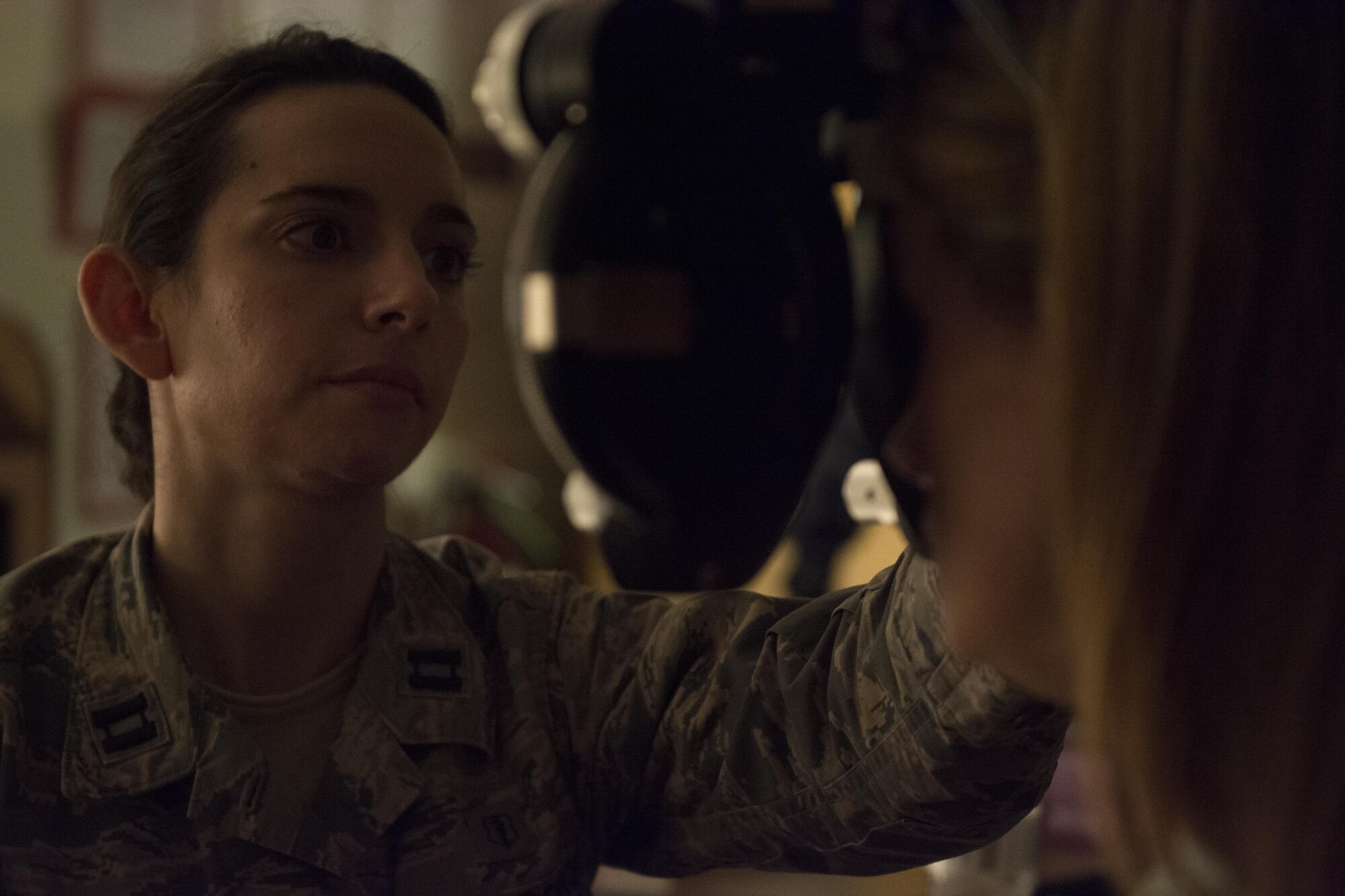Air Force Capt. Alison Hixenbaugh, an optometrist assigned to 514th Dental Squadron, McGuire Air Force Base, Air Force Reserve, N.J., conducts a vision test to a mother of three during  the Smoky Mountain Medical Innovative Readiness Training in Bryson City, N.C., Aug. 3, 2017.