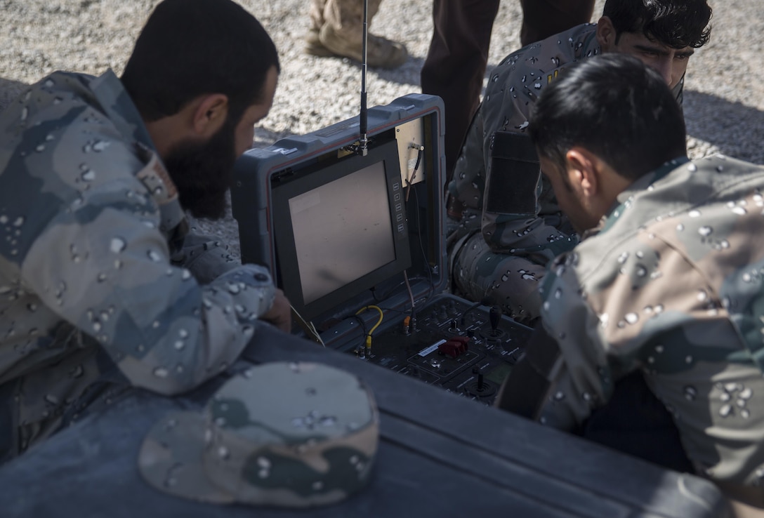 Engineers with the 505th Zone National Police pull a notional improvised explosive device out of the ground utilizing the Talon at Bost Airfield, Afghanistan, June 8, 2017. During the class, the engineers focused on techniques to detect, uncover and destroy IEDs. This training, given by a Marine advisor with Task Force Southwest, aided them in a real-life operational environment during Maiwand 4. (U.S. Marine Corps photo by Sgt. Justin T. Updegraff)