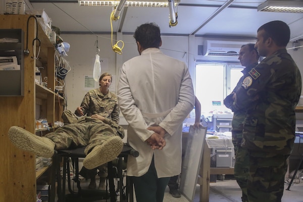A U.S. Army soldier with 2nd Forward Surgical Team, U.S. Forces-Afghanistan demonstrates proper head trauma treatment on a simulated casualty to Afghan National Army medical personnel assigned to 215th Corps at Camp Shorab, Afghanistan, Aug. 9, 2017. Several ANA soldiers from the 215th Corps Hospital collaborated with their U.S. counterparts to enhance their treatment capabilities. The hospital was one of three military hospitals to be awarded the President of Afghanistan’s Medal of Excellence. In 2016, the 215th Corps Hospital conducted approximately 1,800 surgeries and evacuated approximately 700 deceased soldiers to their families. (U.S. Marine Corps photo by Sgt. Lucas Hopkins)