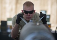 Senior Airman Clayton Sherrill, 455th Expeditionary Maintenance Squadron, aligns a guided bomb unit to the aircraft it will be attached to at Bagram Airfield, Afghanistan, Aug. 4, 2017. Munitions systems Airmen are responsible for the accountability of everything from small arms ammunitions to large-scale guided bomb units. (U.S. Air Force photo by Staff Sgt. Benjamin Gonsier)