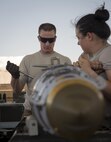 Tech. Sgt. Chris Brunsman installs a tail fuse, as Staff Sgt. Ahbree Wetzel-Lee holds the bomb body steady at Bagram Airfield, Afghanistan, Aug. 4, 2017. Brunsman and Wetzel-Lee are munitions systems specialists, commonly referred to as “AMMO,” assigned to the 455th Expeditionary Maintenance Squadron. (U.S. Air Force photo by Staff Sgt. Benjamin Gonsier)