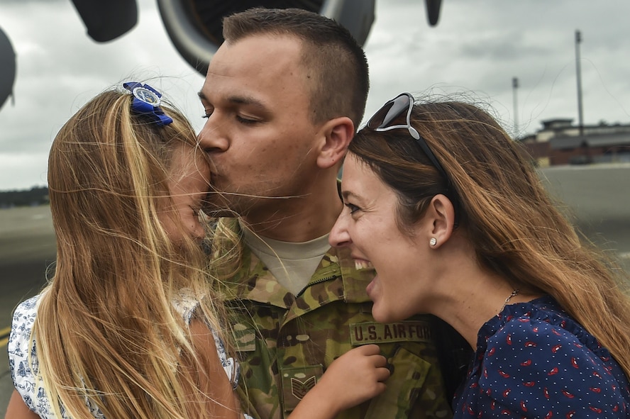 Tech. Sgt. Jason Fatjo, a 14th Airlift Squadron loadmaster, embraces his family after returning from a deployment at Joint Base Charleston, S.C., Aug. 8, 2017. Fatjo and his family have been through five deployments together, each presenting their own challenges. (U.S. Air Force photo/Senior Airman Christian Sullivan)