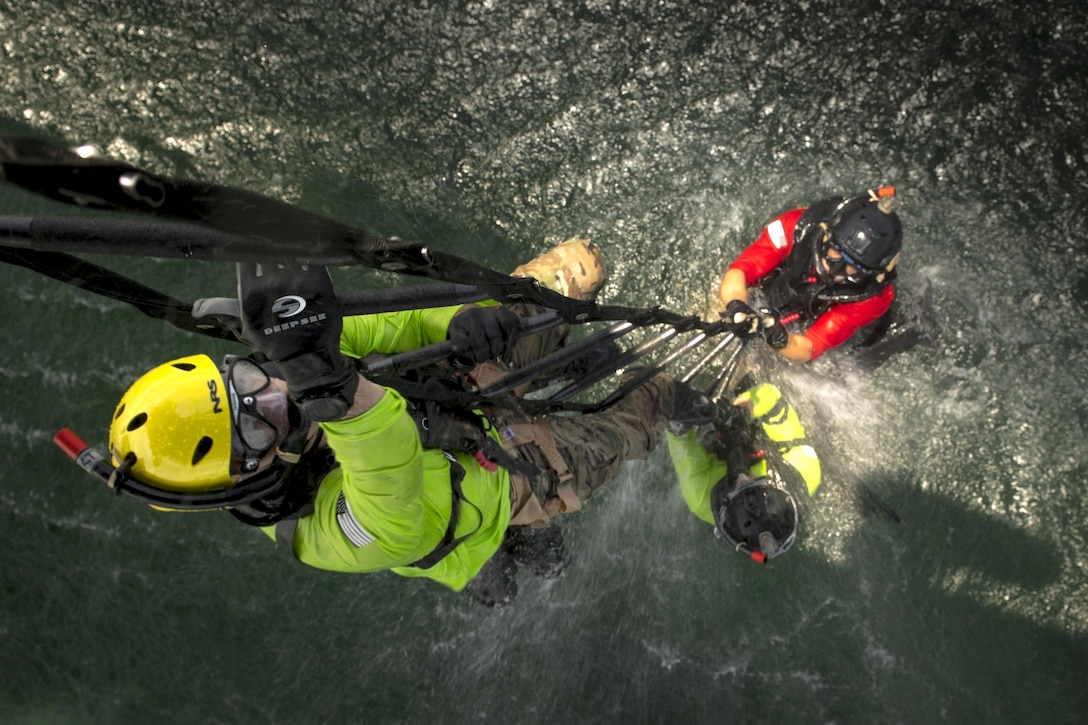 Pararescuemen from the 38th Rescue Squadron climb a ladder into an HH-60G Pave Hawk, Aug. 7, 2017, near Dog Island, Fla. Airmen from the 23d Wing and 325th Fighter Wing conducted daytime water rescue operations training in conjunction with exercise Stealth Guardian, which is designed to test aircrews with real-world exercise scenarios similar to a deployed or contingency environment. (U.S. Air Force photo/Staff Sgt. Ryan Callaghan)