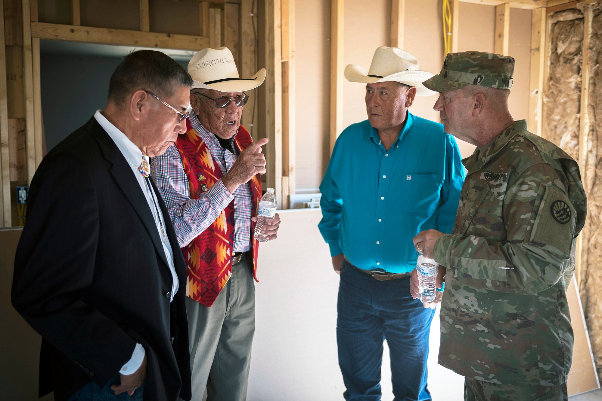 U.S. Army Brig. Gen. Robert Sparing, the assistant adjutant general-Army for the Montana National Guard, talks with Crow tribal leaders in veteran home in Crow Agency, Mont., July 26, 2017. The Innovative Readiness Training program is a civil-military relations cooperative that provided hands-on training for military members who built and renovated homes for Crow military veterans. (U.S. Air National Guard photo by Tech. Sgt. Lealan Buehrer)