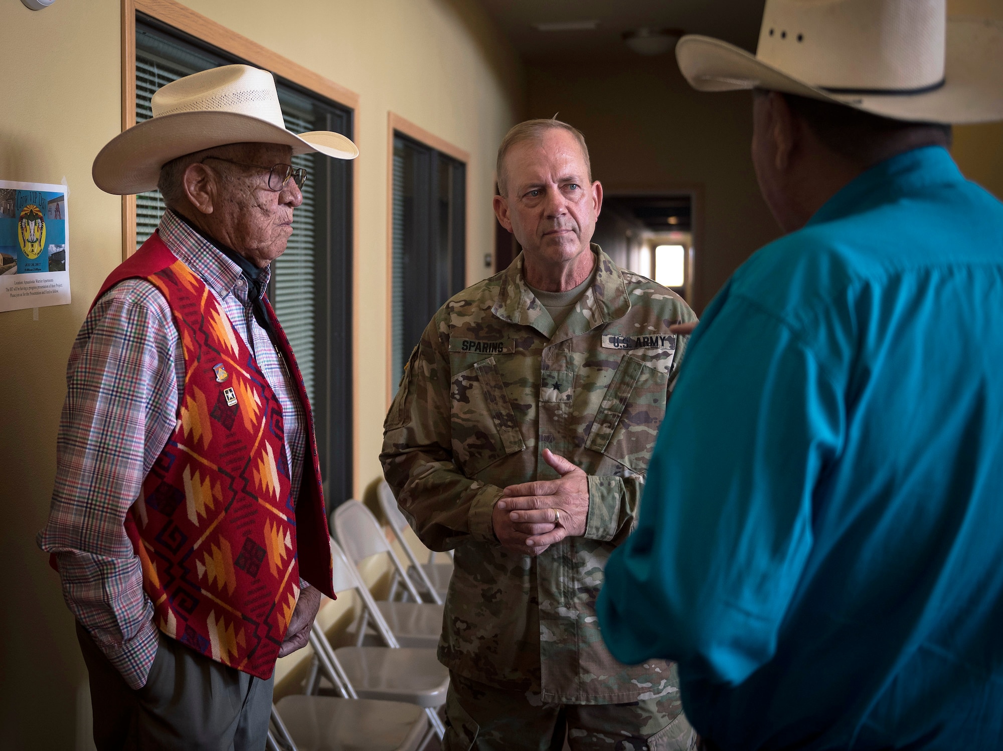 U.S. Army Brig. Gen. Robert Sparing, the assistant adjutant general-Army for the Montana National Guard, speaks to tribal leaders Newton Old Crow, left, and Oliver Half before the Innovative Readiness Training opening ceremony in Crow Agency, Mont., July 26, 2017. The IRT program is a civil-military relations cooperative that provided hands-on training for military members who built and renovated homes for Crow military veterans. (U.S. Air National Guard photo by Tech. Sgt. Lealan Buehrer)