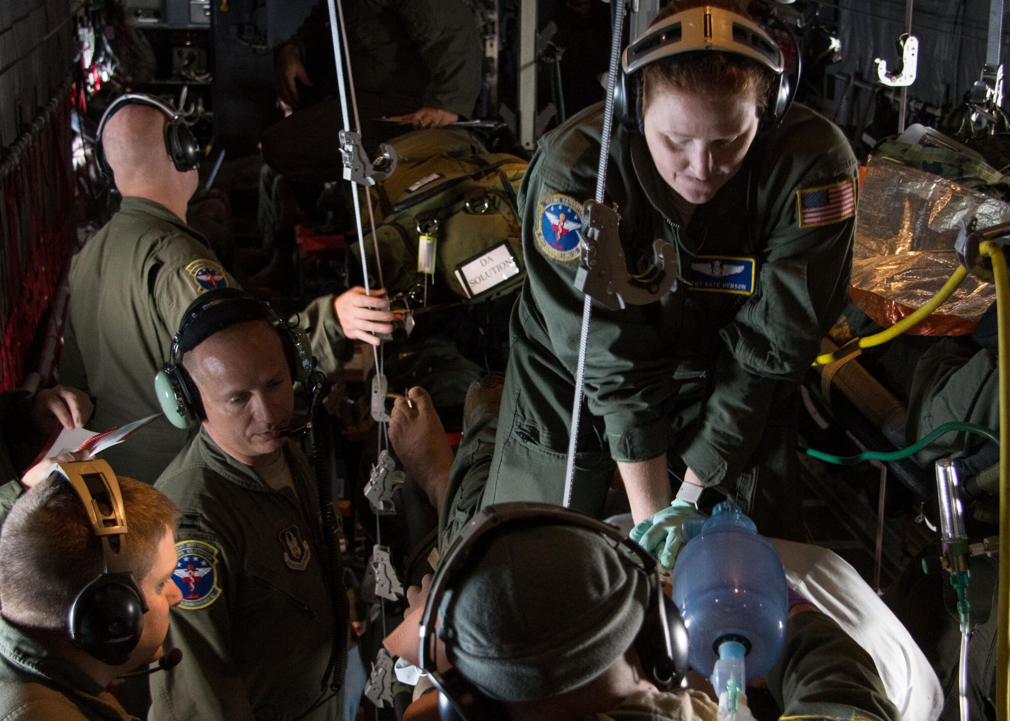 Tech. Sgt. Katherine Henson, 94th Aeromedical Evacuation Squadron flight medic, performs compressions on a medical-training dummy simulating cardiac arrest aboard a C-130H Hercules July 27, 2017. In addition to compressions, the medics also used a defibrillator to deliver electric currents to the patient’s heart. (U.S. Air Force photo/Staff Sgt. Andrew Park)