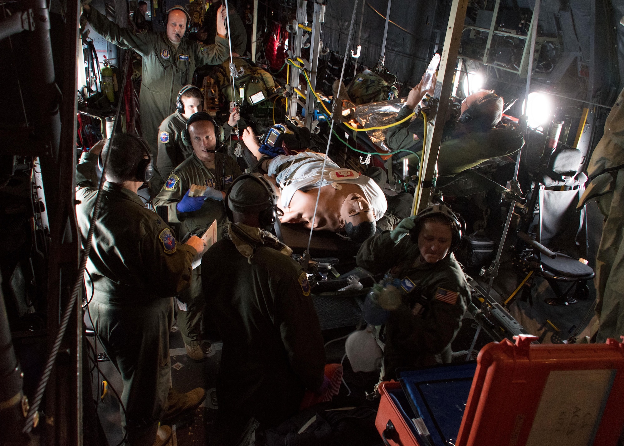 Members of the 94th Aeromedical Evacuation Squadron surround a medical-training dummy simulating cardiac arrest aboard a C-130H Hercules July 27, 2017. The nurses identified that the patient was pulseless, so they moved into performing CPR. (U.S. Air Force photo/Staff Sgt. Andrew Park)