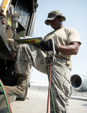 U.S Air Force Tech. Sgt. Jason Johnson, a fuels specialist with the 379th Expeditionary Logistics Readiness Squadron, Fuels Management Flight, records the fuel output at Al Udeid Air Base, Qatar, July 24, 2017.