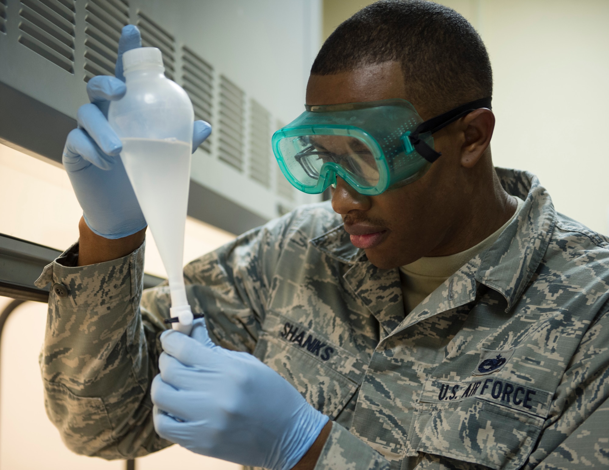 U.S Air Force Staff Sgt. Mario Shanks, non-commission officer in charge of the fuels lab with the 379th Expeditionary Logistics Readiness Squadron, Fuels Management Flight, performs a quality control test at Al Udeid Air Base, Qatar, July 24, 2017.