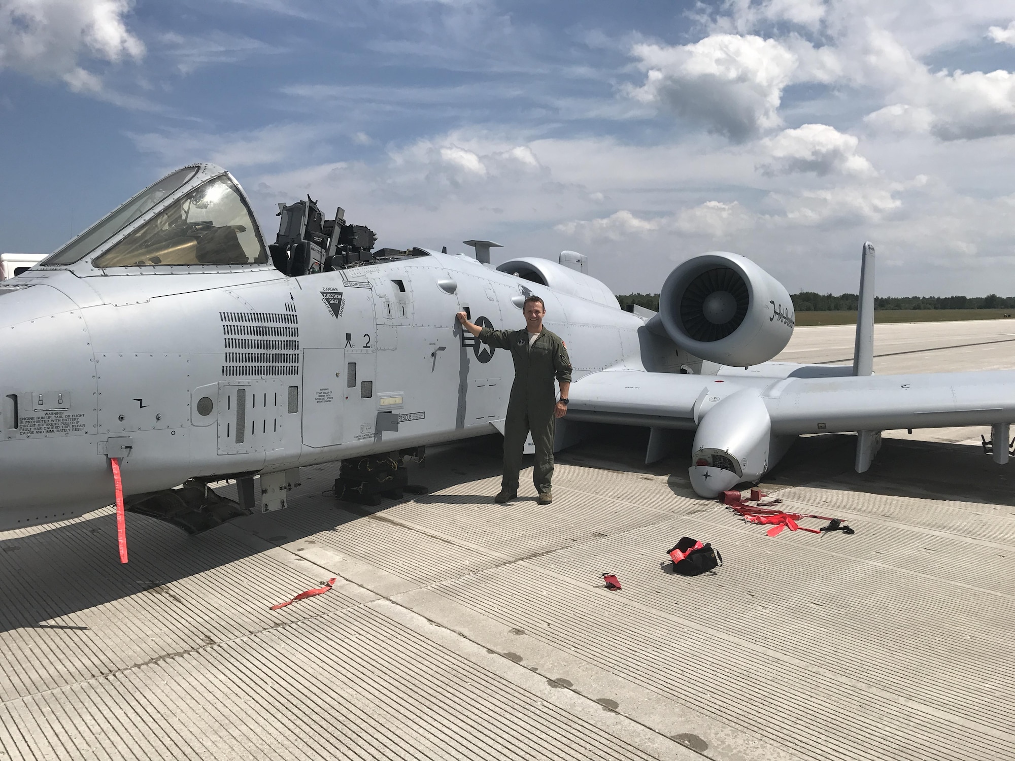 Capt. Brett DeVries, an A-10 Thunderbolt II pilot of the 107th Fighter Squadron from Selfridge Air National Guard Base, poses next to the aircraft he safely landed after a malfunction forced him to make an emergency landing July 20 at the Alpena Combat Readiness Training Center.  (Photo courtesy U.S. Air National Guard)