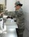 U.S. Air Force Technical Sgt. Alina Ness, non-commissioned officer of food safety and sanitation assigned to the Public Health Element of the 379th Expeditionary Medical Group, uses her infrared thermometer to determine the surface temperature of food stored in a refrigerated serving station during an inspection of the a dining facility at Al Udeid, Air Base, Qatar, July 22, 2017. The members of the 379th EMDG/SGOL work behind the scenes to help keep Airmen deployed here healthy by inspecting public facilities, ensuring the medical readiness of forward deploying Airmen and by tracking and working to prevent the spread of communicable diseases. (U.S. Air National Guard photo by Tech. Sgt. Bradly A. Schneider/Released)
