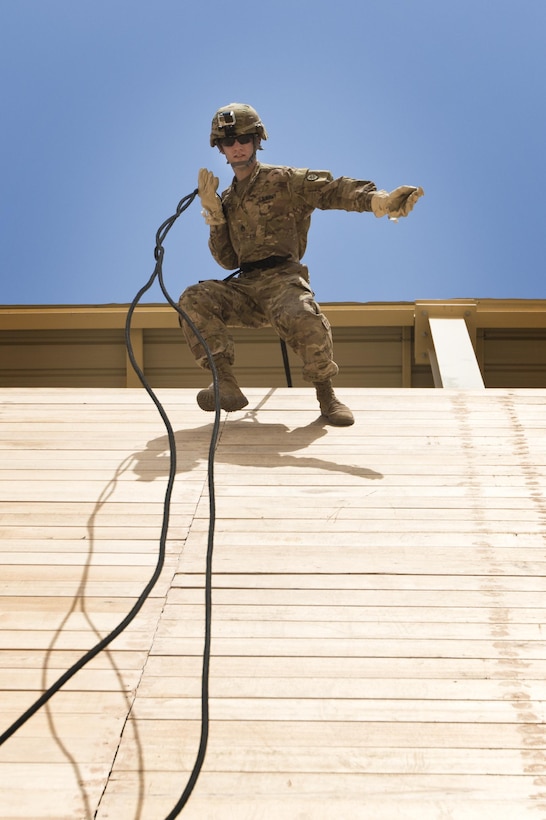 Staff Sgt. Dalton Smith, public affairs noncommissioned officer incharge with the 316th Sustainment Command (Expeditionary), a U.S. Army Reserve unit based out of Coraopolis, Pa., currently deployed to the U.S. Central Command, rap “aussie” rappels off of a tower during a professional development training at Camp Buehring, Kuwait, on July 31, 2017. (U.S. Army photo by Spc. Chevele Crawford)