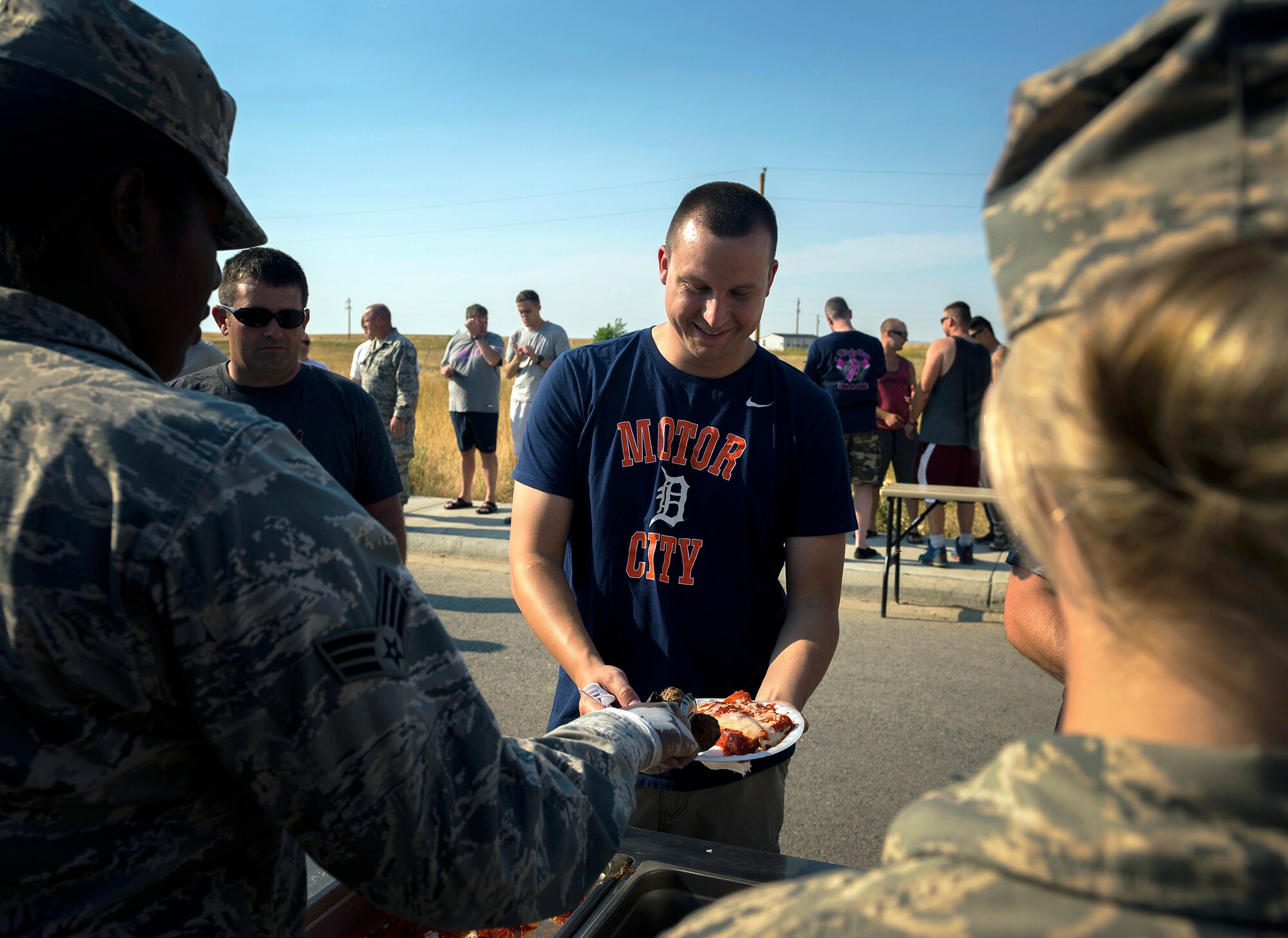 U.S. Air Force Senior Airman Derek Elsey, a water and fuel systems maintenance specialist with the 182nd Civil Engineer Squadron, Illinois Air National Guard, gets manicotti and meatballs for dinner in Crow Agency, Mont., Aug. 1, 2017. Force Support Squadron services specialists provided meal support to the squadron’s unit members while they built veterans’ homes for the Innovative Readiness Training program. (U.S. Air National Guard photo by Tech. Sgt. Lealan Buehrer)