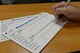 A member of Team Whiteman fills out a tracking card for the running club at Whiteman Air Force Base, Mo.,
August 8, 2017. The fitness center has a running club with three different mile markers of
100 miles, 250 miles and 509 miles. By using the tracking card members can see how close they are to the next mile marker.