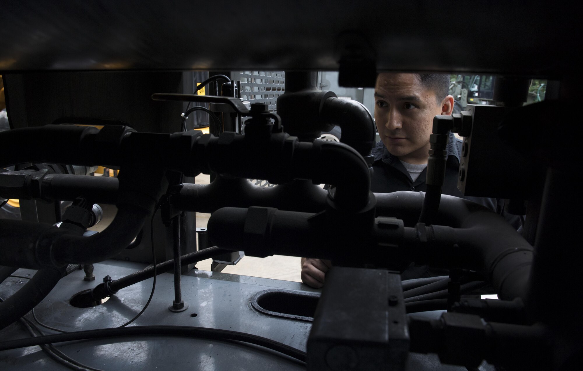 U.S. Air Force Senior Airman Joey James, 86th Vehicle Readiness Squadron Special Purpose maintenance technician, inspects the inner workings of a standard deicing truck for the squadron’s Summer Rebuild Program on Ramstein Air Base, Germany, Aug. 8, 2017. The 86th VRS inspects and repairs all snow removal vehicles on Ramstein every summer during the rebuild program to ensure they are fully operational for the winter months. (U.S. Air Force photo by Senior Airman Tryphena Mayhugh)