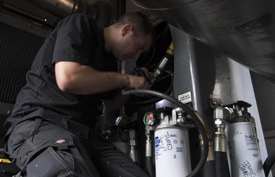 Senior Airman Zachary Howlett, 86th Vehicle Readiness Squadron Special Purpose maintenance technician, pulls out the boom length hydraulic hose for a standard deicing truck on Ramstein Air Base, Germany, Aug. 10, 2017. Howlett and other Airmen in his shop have been inspecting and repairing every winter maintenance vehicle on Ramstein since April 1 to prepare for the upcoming season. (U.S. Air Force photo by Senior Airman Tryphena Mayhugh)