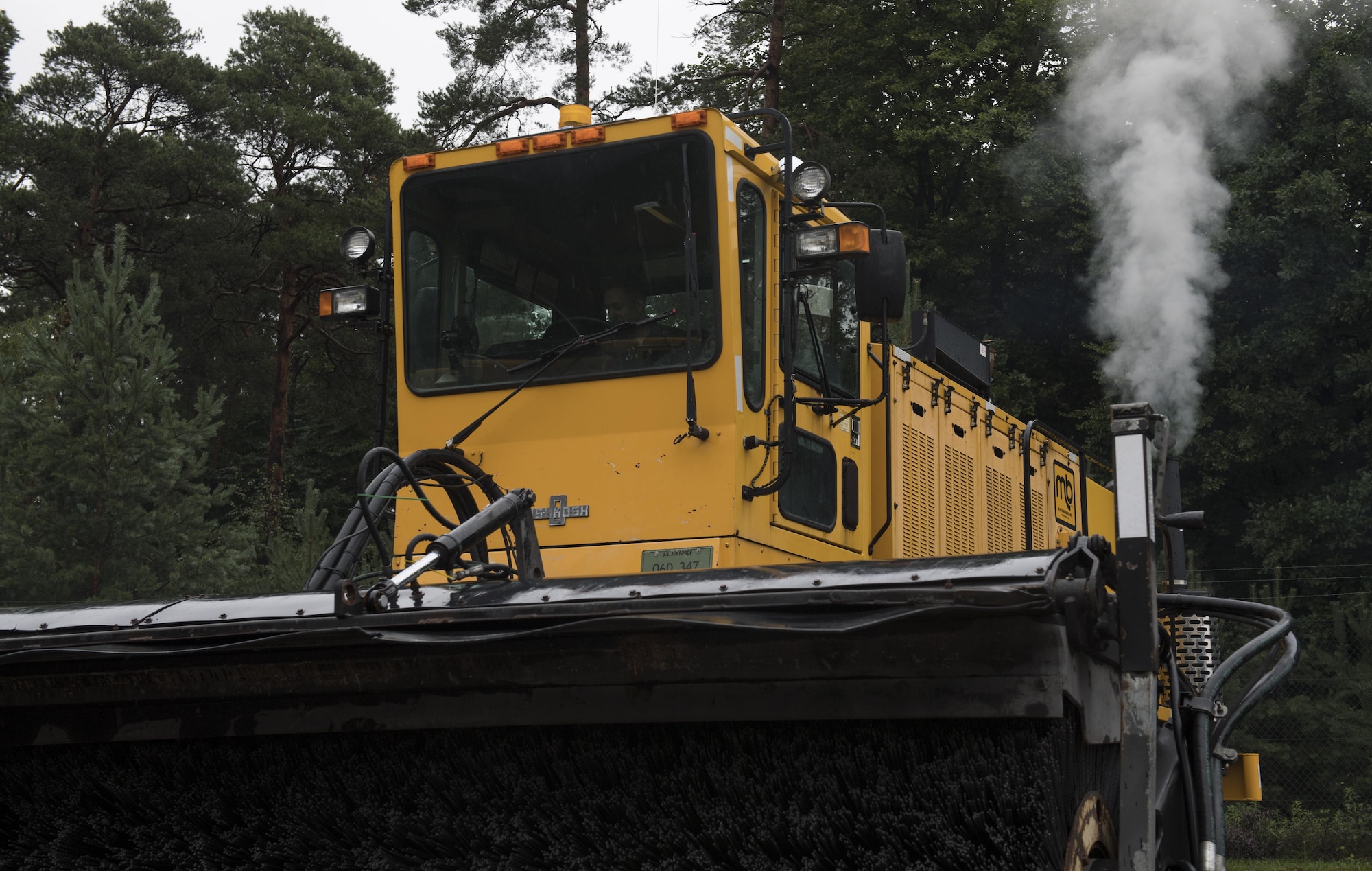 U.S. Air Force Staff Sgt. Zachary Simmons, 86th Vehicle Readiness Squadron Special Purpose maintenance supervisor, starts up a snow removal vehicle with a snow brush attachment during the squadron’s Summer Rebuild Program on Ramstein Air Base, Germany, Aug. 10, 2017. During the program, which runs from April 1 to Oct. 1, the 86th VRS receives, inspects, and repairs all winter maintenance vehicles to ensure they are fully operational for the winter months. (U.S. Air Force photo by Senior Airman Tryphena Mayhugh)