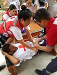 Members of the Honduran Red Cross participate in a hands-on practical exercise to stop inguinal bleeding during a four-hour pre-hospital training course July 22 in Tegucigalpa, Honduras.