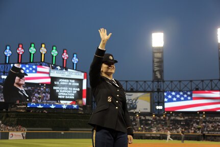 Sgt. Maribel Cano-Meraz, assigned to the 85th Support Command headquartered in Arlington Heights, Illinois, waves to the crowd at the Chicago White Sox vs. Houston Astros game during a ‘Hero of the Game’ military recognition, there, at Guaranteed Rate Field.