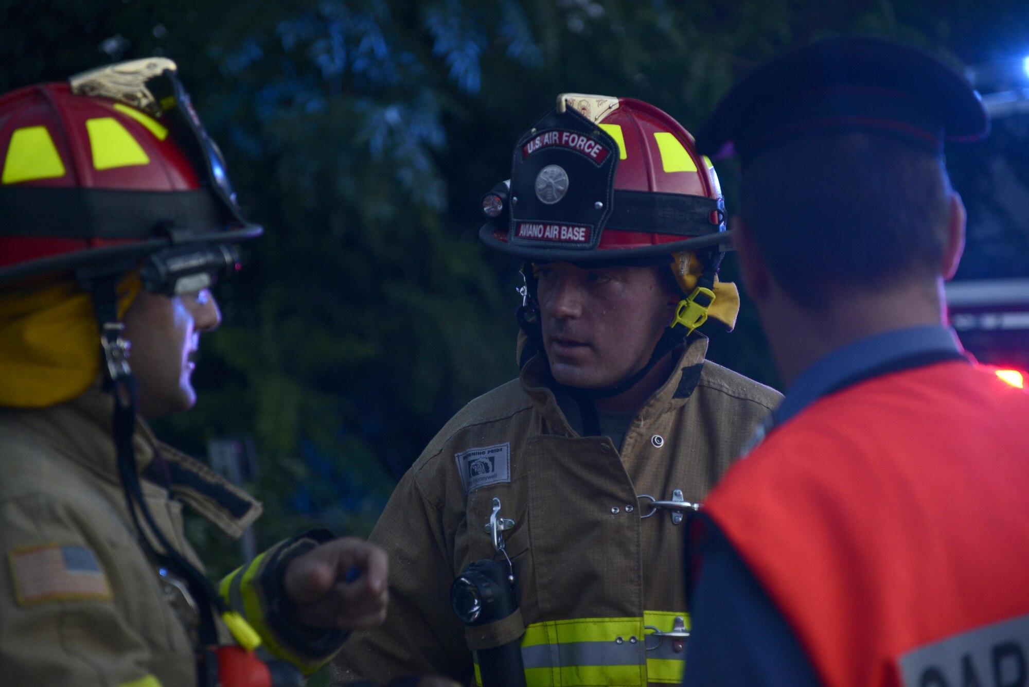 Aviano Air Base firefighters and a Carabinieri military police officer discuss removing a tree from a highway Aug. 10, 2017, in Pordenone Province, Italy. The 31st CES firefighters teamed with local first responders to clear roadways after heavy thunderstorms passed through the area. (U.S. Air Force photo by Tech. Sgt. Andrew Satran)