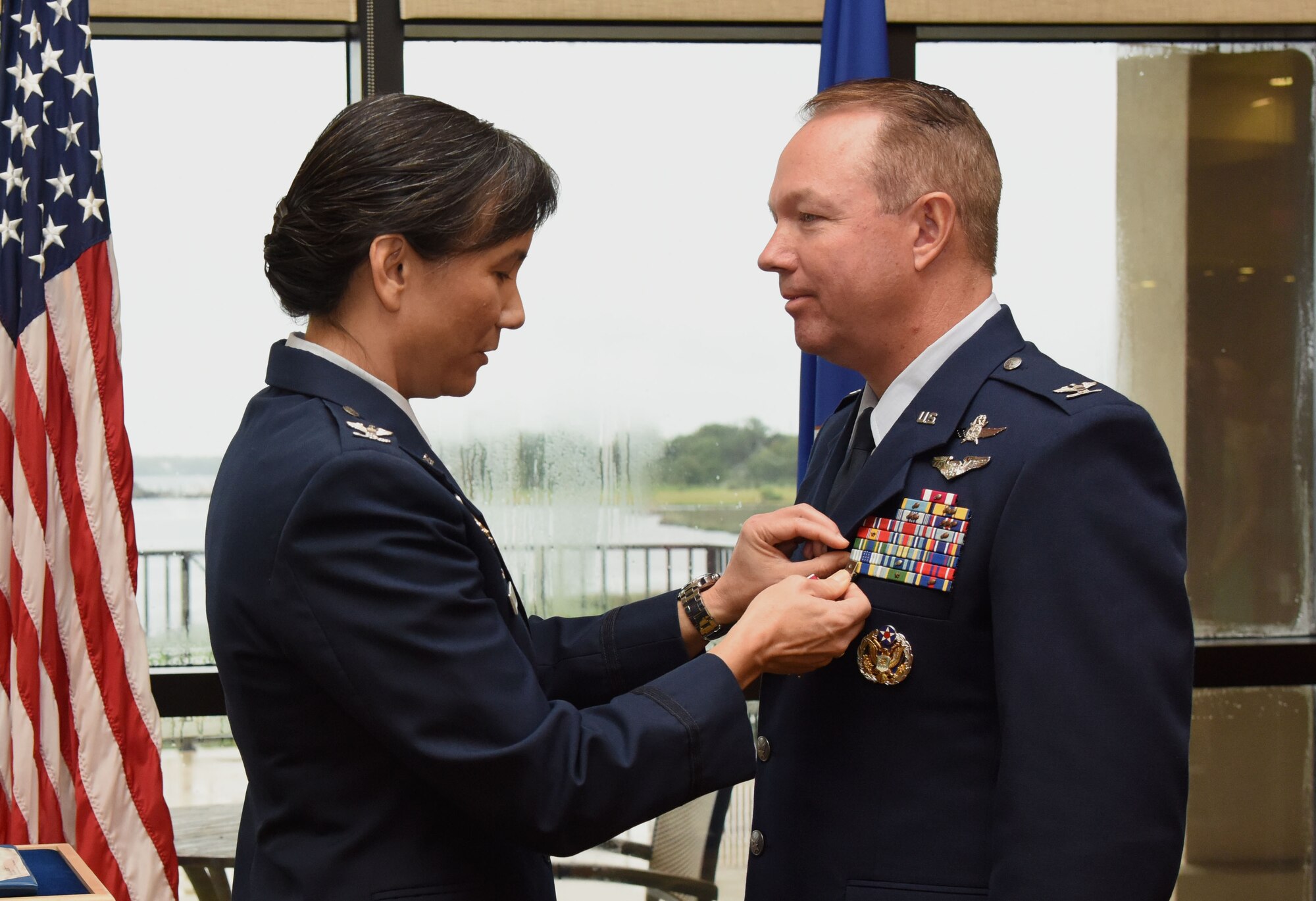 Col. Debra Lovette, 81st Training Wing commander, presents the Legion of Merit medal to Col. Scott Solomon, outgoing 81st Training Group commander, during the 81st TRG change of command ceremony in the Bay Breeze Event Center Aug. 4, 2017, on Keesler Air Force Base, Miss. The ceremony is a symbol of command being exchanged from one commander to the next by the hand off of a ceremonial guidon. Solomon passed on command of the 81st TRG to Col. Leo Lawson, Jr. (U.S. Air Force photo by Kemberly Groue)