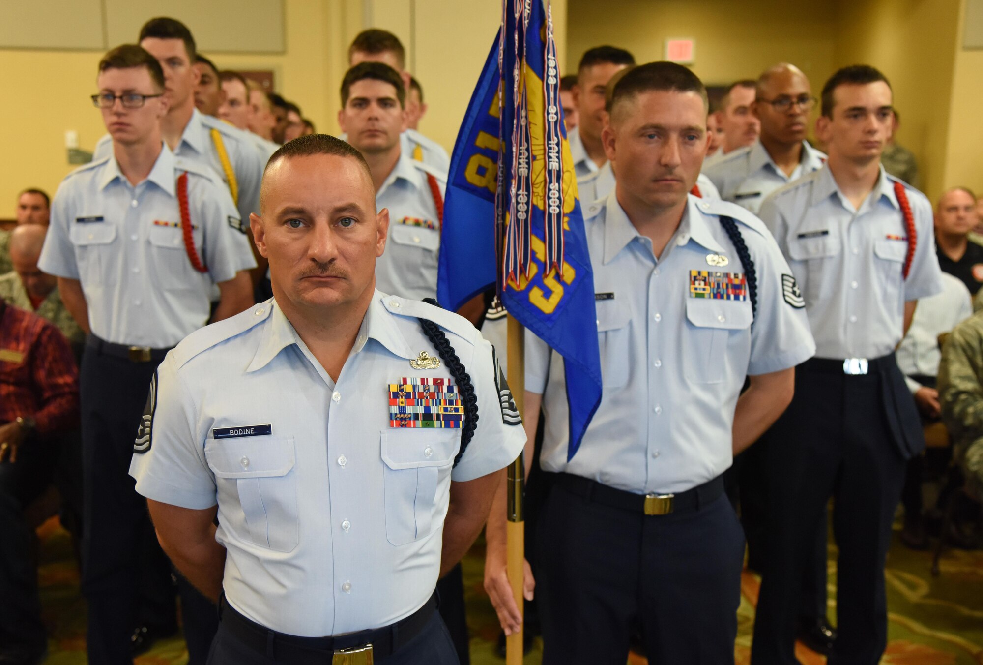 Senior Master Sgt. Andrew Bodine, 81st Training Group military training superintendent, and Airmen from the 81st TRG stand in formation during the 81st TRG change of command ceremony in the Bay Breeze Event Center Aug. 4, 2017, on Keesler Air Force Base, Miss. The ceremony is a symbol of command being exchanged from one commander to the next by the hand off of a ceremonial guidon. (U.S. Air Force photo by Kemberly Groue)