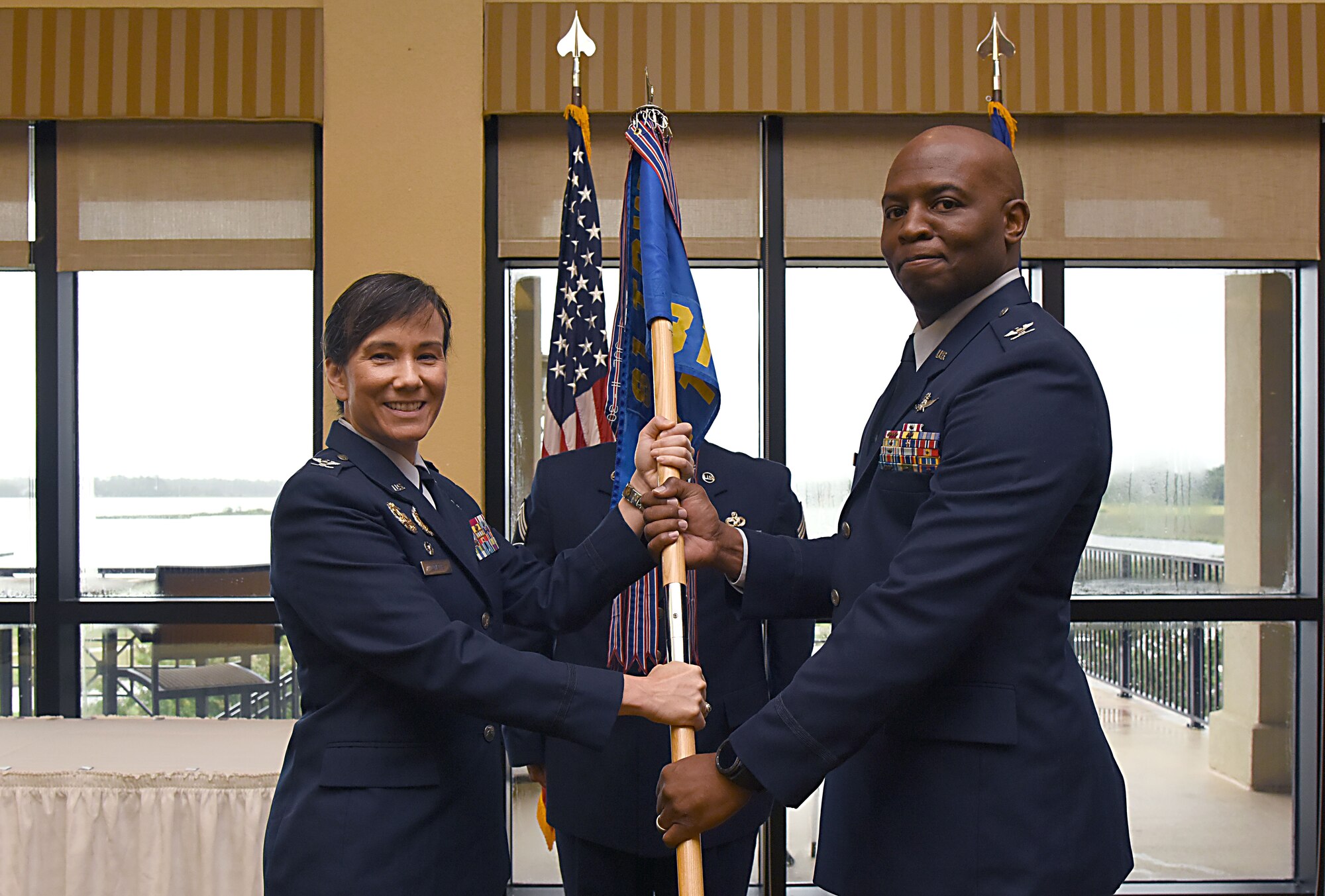 Col. Debra Lovette, 81st Training Wing commander, passes command of the 81st Training Group to Col. Leo Lawson, Jr., 81st Training Group commander, during the 81st TRG change of command ceremony in the Bay Breeze Event Center Aug. 4, 2017, on Keesler Air Force Base, Miss. The ceremony is a symbol of command being exchanged from one commander to the next by the hand off of a ceremonial guidon. (U.S. Air Force photo by Kemberly Groue)