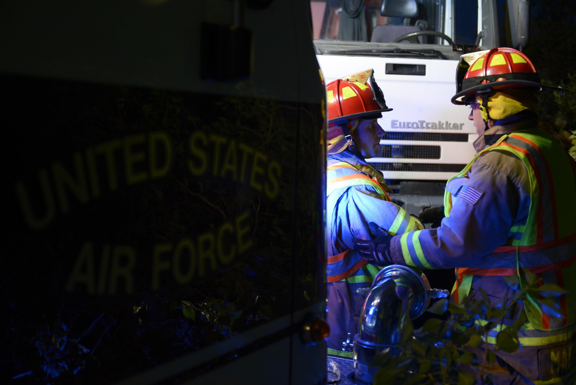 Staff Sgt. Jason Holmes and Tech. Sgt. Brian Martenis, 31st Civil Engineer Squadron firefighters, discuss removing a tree from highway Aug. 10, 2017, in Pordenone Province, Italy. The 31st CES firefighters teamed with local first responders to clear roadways after heavy thunderstorms passed through the area. (U.S. Air Force photo by Tech. Sgt. Andrew Satran)