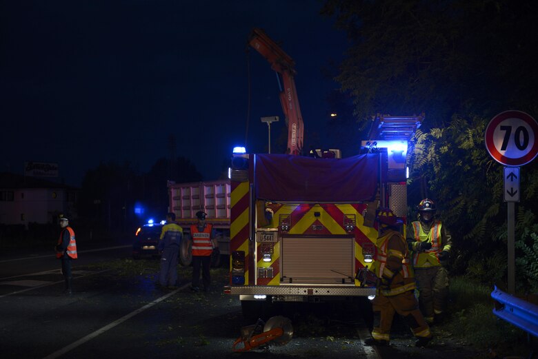Staff Sgt. Jason Holmes and Tech. Sgt. Brian Martenis, 31st Civil Engineer Squadron firefighters, prepare to remove a tree from a highway Aug. 10, 2017, in Pordenone Province, Italy. The 31st CES firefighters teamed with local first responders to clear roadways after heavy thunderstorms passed through the area. (U.S. Air Force photo by Tech. Sgt. Andrew Satran)