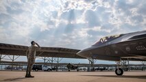 Airman 1st Class Luigi Amoriello, 388th Aircraft Maintenance Squadron, and Maj. James Schmidt, 388th Operations Group, exchange salutes during launch operations at Hill Air Force Base, Aug. 7. The Airmen and F-35A Lightning II aircraft were participating in Combat Hammer, part of the Weapons System Evaluation Program. For Amoriello, from Little Egg Harbor, New Jersey, the launch was his first solo effort. (Paul Holcomb/U.S. Air Force)