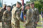 The Army Medical Department Center & School’s incoming Command Sgt. Maj. William “Buck” O’Neal accepts the colors from Maj. Gen. Brian C. Lein, commanding general, AMEDDC&S, while outgoing Command Sgt. Maj. Andrew J. Rhoades looks on.