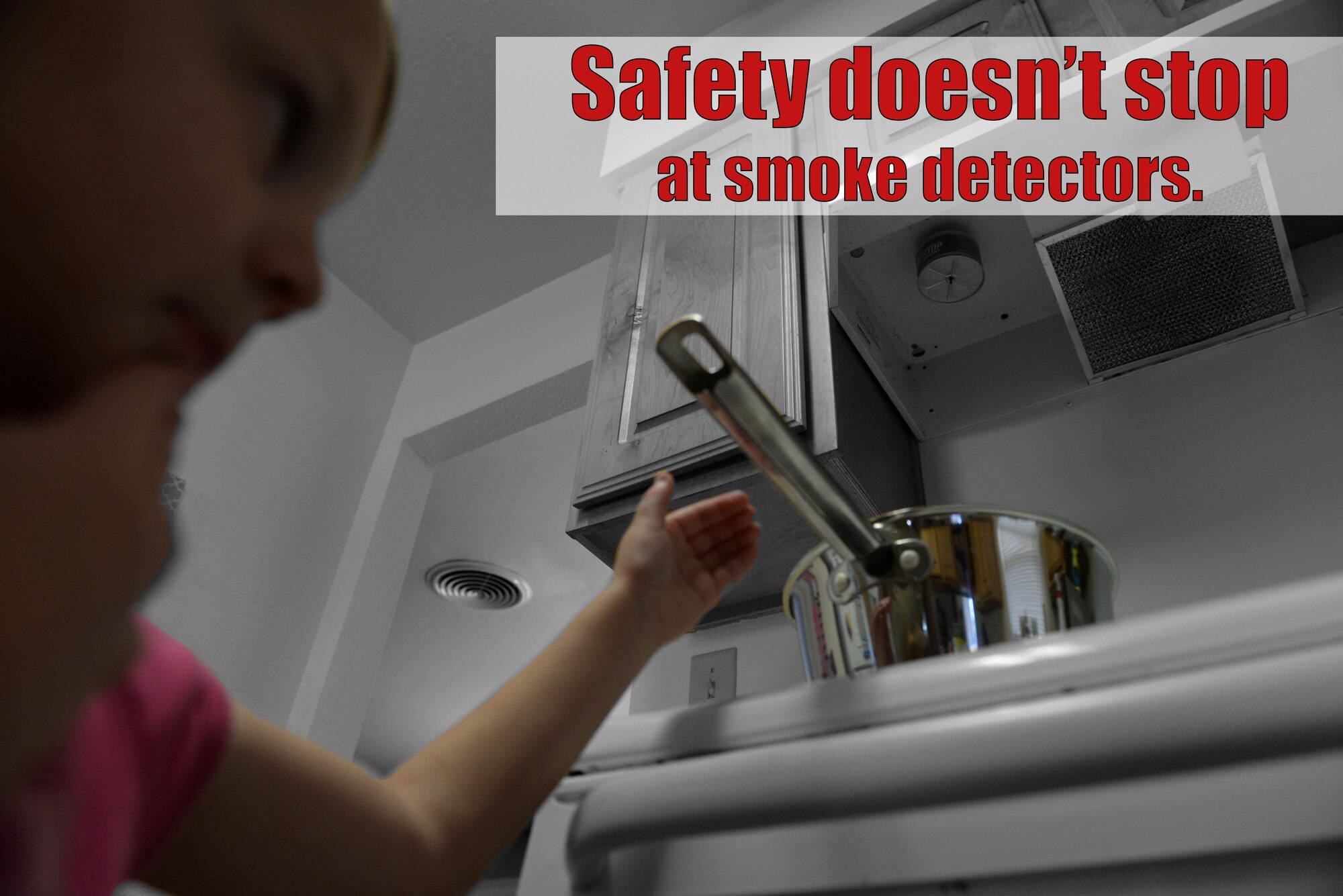 Anna Grace McGuffin, age 4, reaches for a pot on top of the stove, Aug. 4, 2017, in base housing on Little Rock Air Force Base, Ark. Handles for cooking equipment on counters and stove tops should be faced inward to keep children from grabbing them and spilling their contents onto themselves. (U.S. Air Force photo illustration by Airman Rhett Isbell)