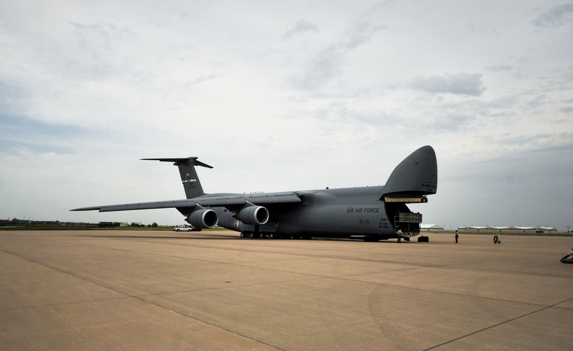 Loadmasters from Travis Air Force Base, Calif., prepare a C-5M Super Galaxy for loading July 26, 2017, on the runway at McConnell Air Force Base, Kan.  The plane transported cargo for exercise Mobility Guardian 2017, which gave future KC-46A Pegasus boom operators the opportunity to see another airlift platform before they attend KC-46 cargo training. (U.S. Air Force Photo/2nd Lt. Daniel de La Fe)