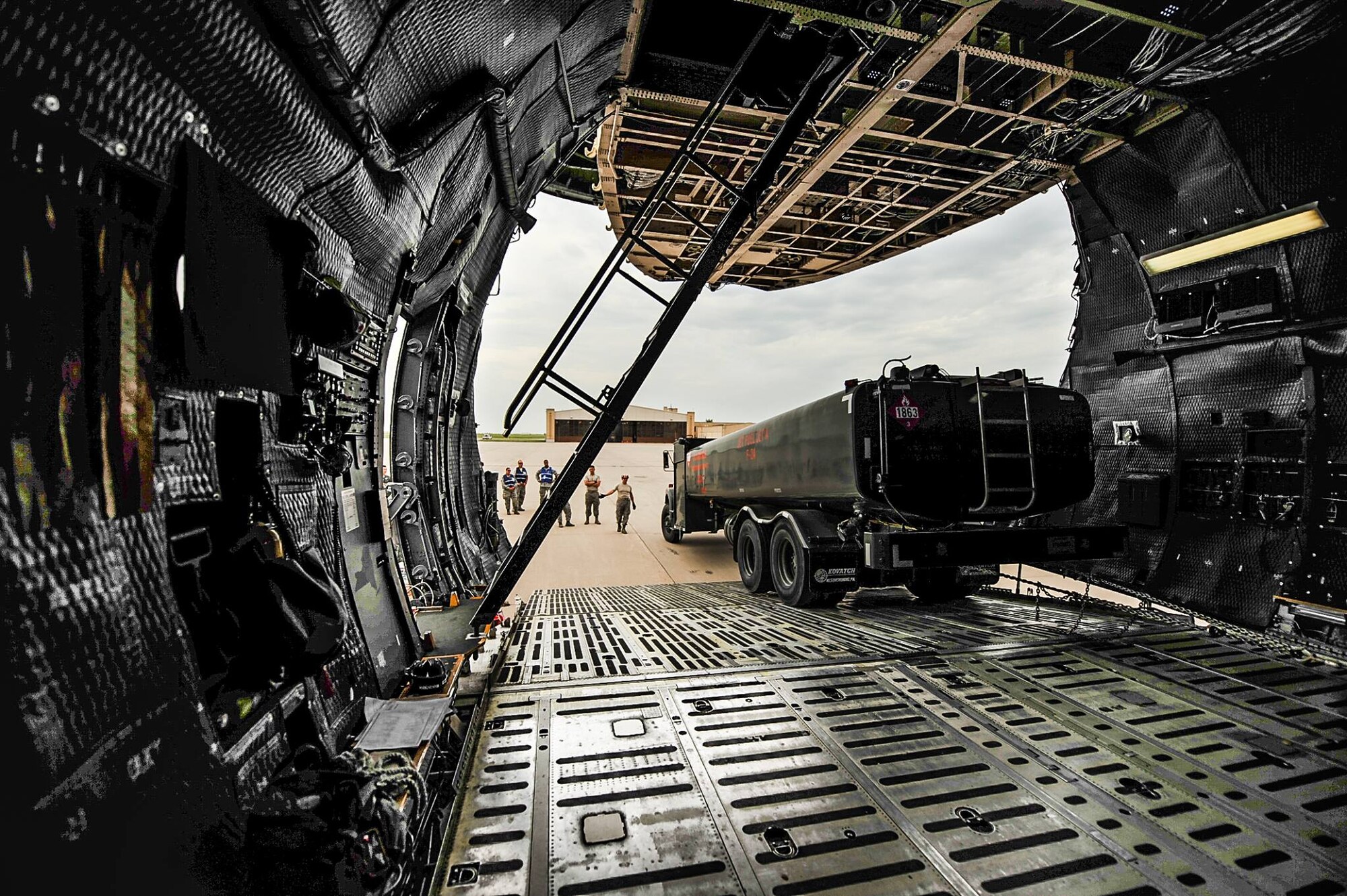 KC-135 Stratotanker boom operators and pilots watch as a fuel truck is loaded onto a C-5M Super Galaxy July 26, 2017, at McConnell Air Force Base, Kan.  Many of the boom operators and pilots are in training for the new KC-46A Pegasus, a multirole aircraft with greater airlift capabilities similar to the Super Galaxy. (U.S. Air Force photo/2nd Lt.  Daniel de La Fe)