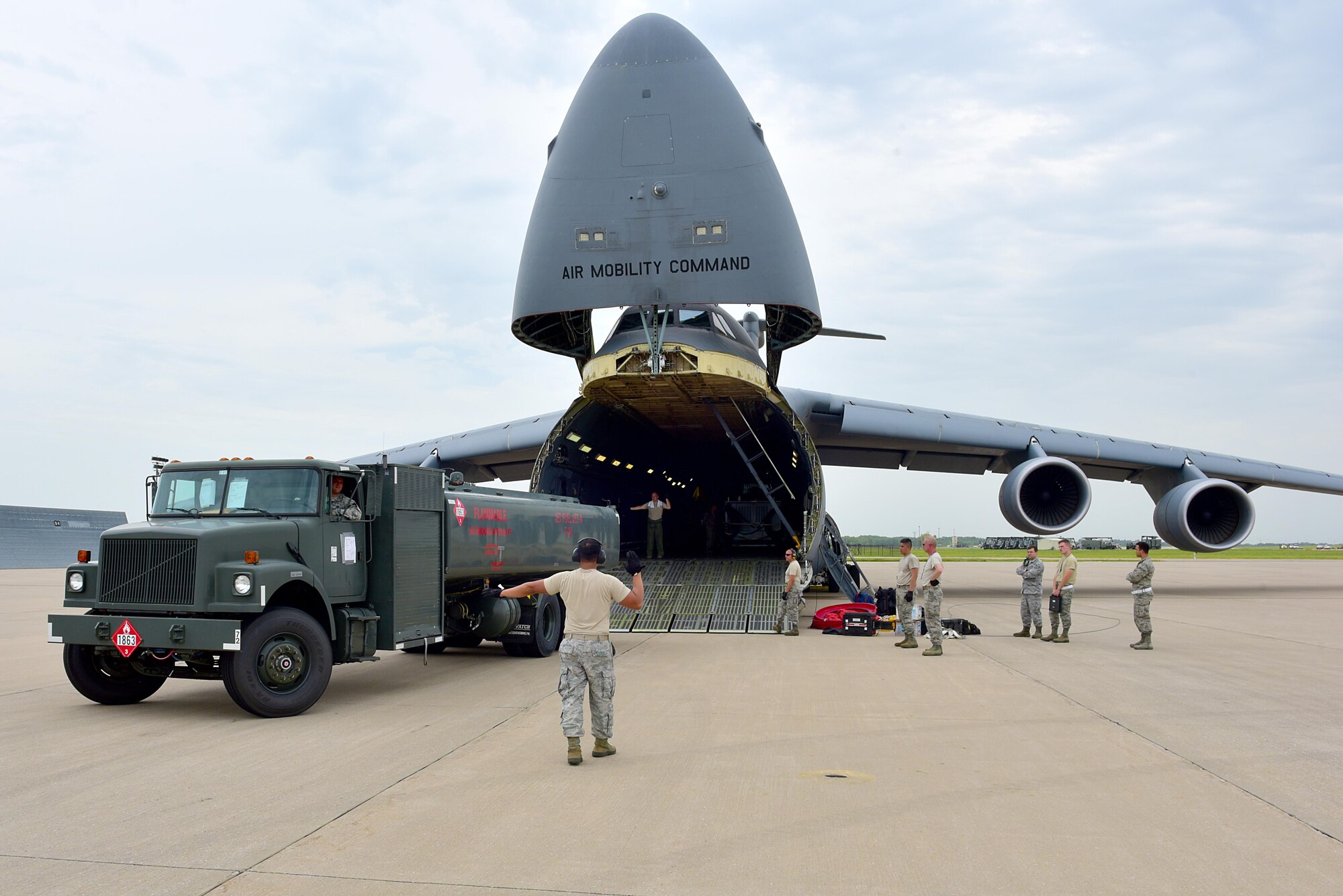 Load masters from Travis Air Force Base, Calif., and 22nd LRS logisticians work together to load a fuel truck onto a C-5M Super Galaxy July 26, 2017, at McConnell Air Force Base, Kan.  The fuel trucks were transported as part of Mobility Guardian 2017, which is Air Mobility Command’s largest exercise of the year. (U.S. Air Force photo/Staff Sgt. Trevor Rhynes)