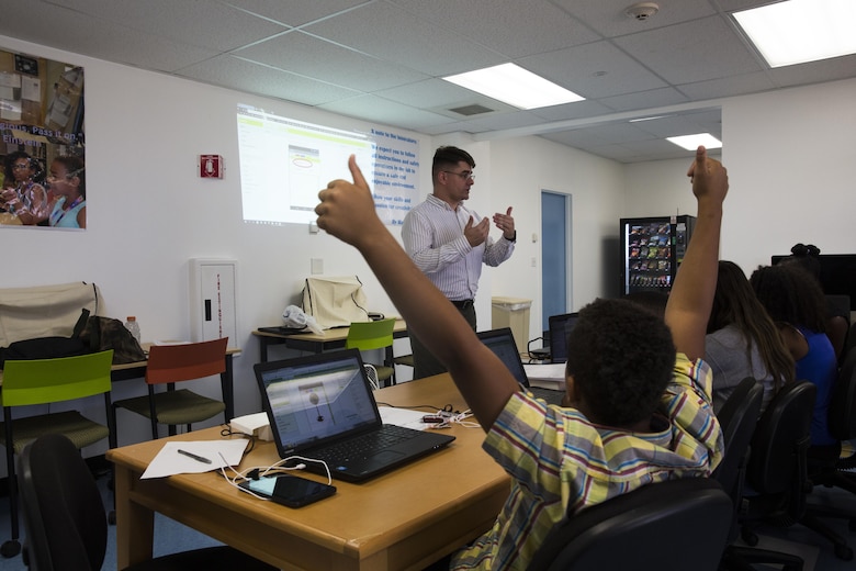 Moses Key, student, Maker Space Lab, shows his understanding of the class with two thumbs up at the Shadow Mountain Branch Library aboard the Marine Corps Air Ground Combat Center, Twentynine Palms, Calif., August 9, 2017. The library conducted the lab to foster excitement about the future of technology in children from military parents and open their minds to positive opportunities. (U.S. Marine Corps photo by Pfc. Margaret Gale)