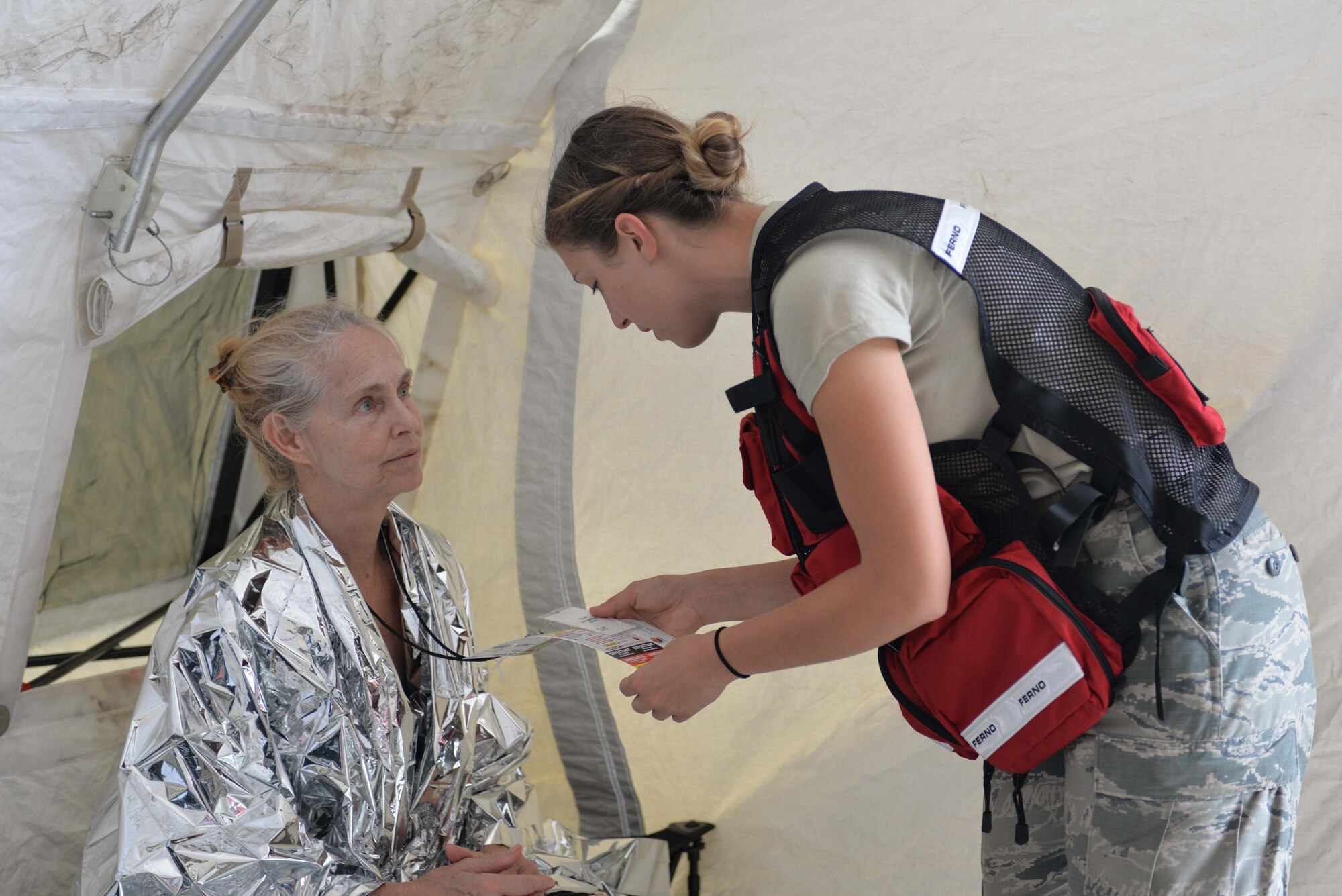 Airman 1st Class Ashly Shipman, CERFP Medical Response Team member and medical technician assigned to the 157th Medical Group at Pease Air National Guard Base, N.H.,  assesses a patient during the notional mass-causualty CERFP New England training exercise held at Fort Indiantown, Pa. (U.S. Air National Guard photo by Master Sgt. Thomas Johnson)