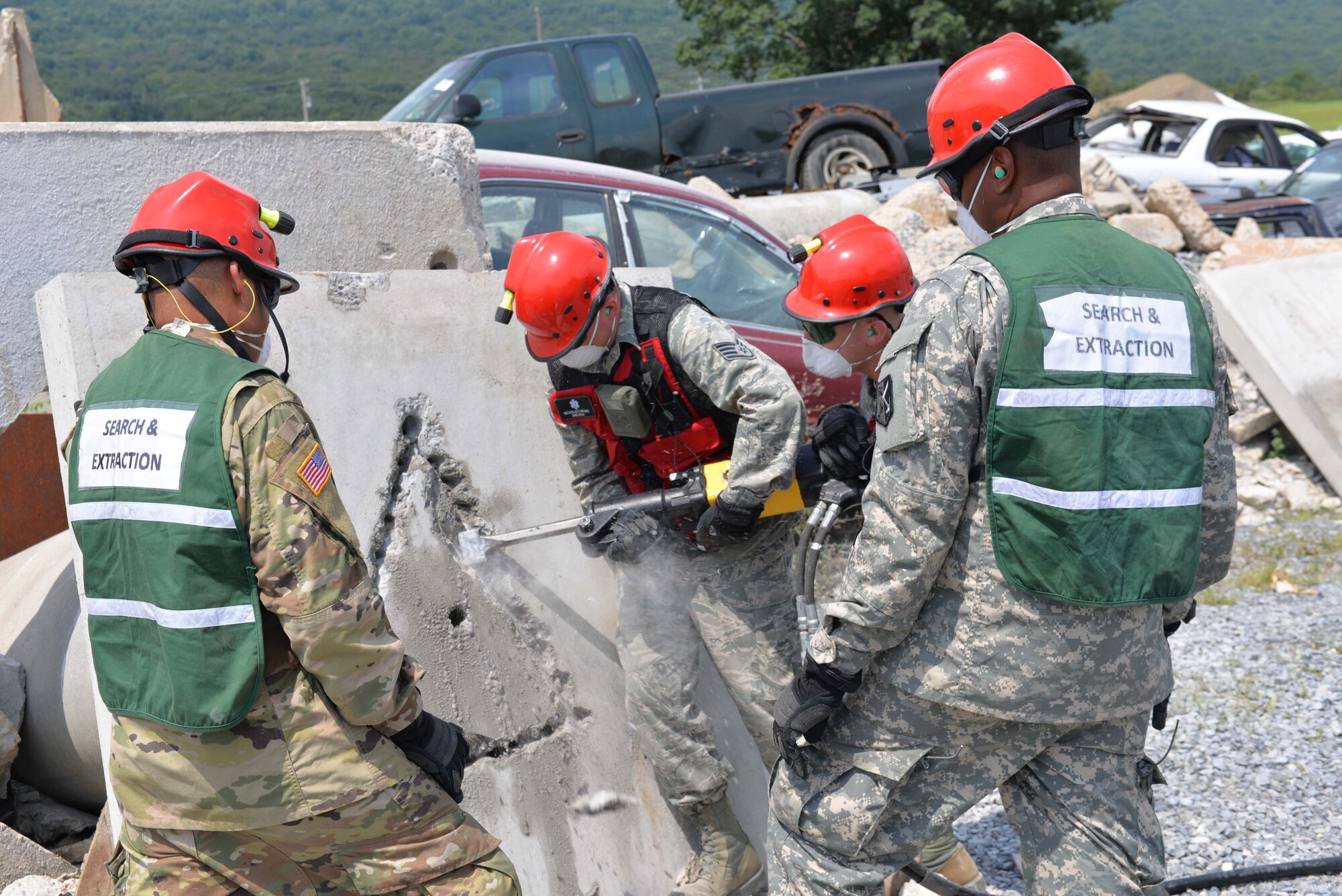 Members of the CERFP Search and Extraction Team, practice breeching heavy concrete during the mass casualty training exercise called CERFP New England on August 10, 2017 at Fort Indiantown, Pa. (U.S. Air National Guard photo by Master Sgt. Thomas Johnson)